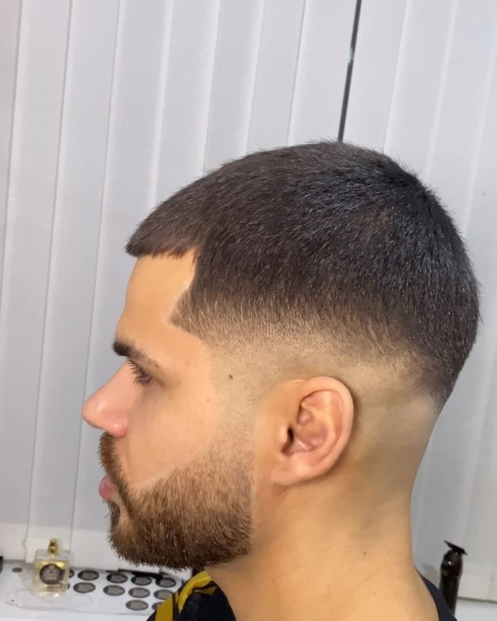 Side profile: mid fade with the beard shaped and lined up