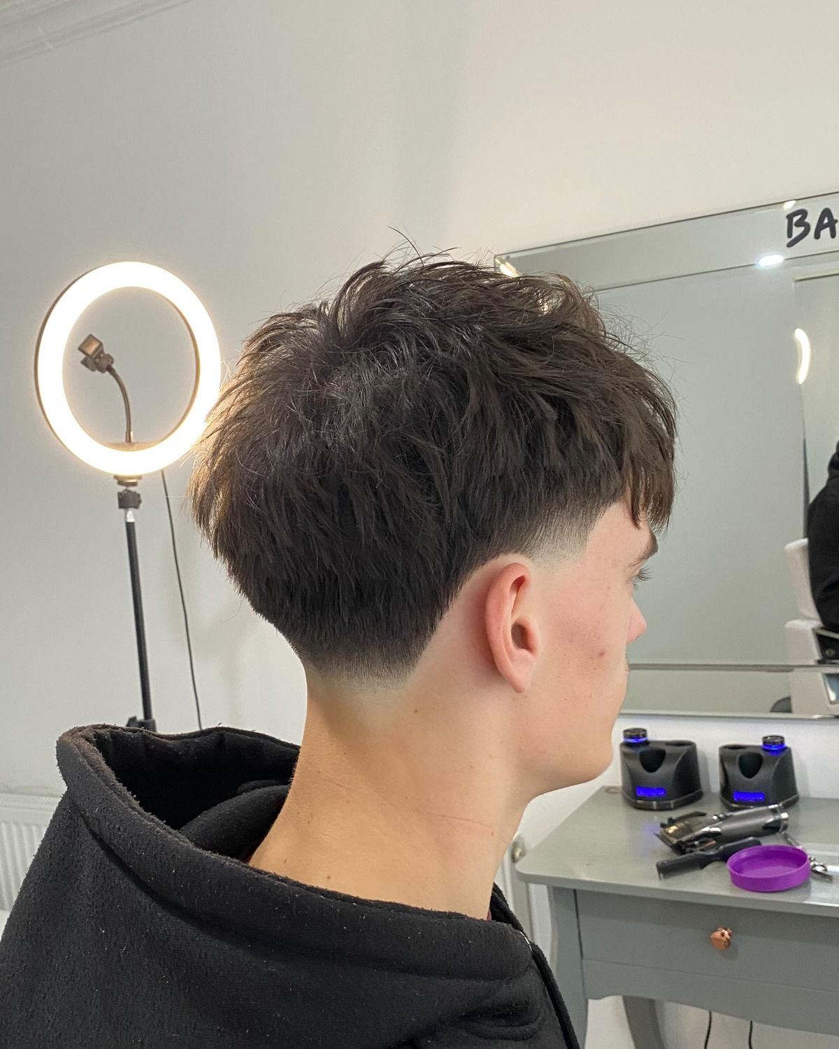 Textured fringe with a mid taper fade