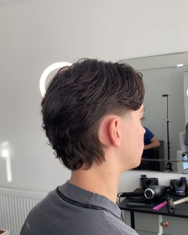 Side view of a modern mullet, tapered around the ear